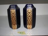 two blue vases sitting on a white table
