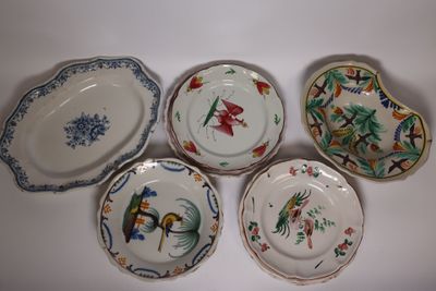 four plates with different designs on them sitting on a white surface