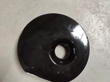 a black donut sitting on the floor next to a pair of shoes