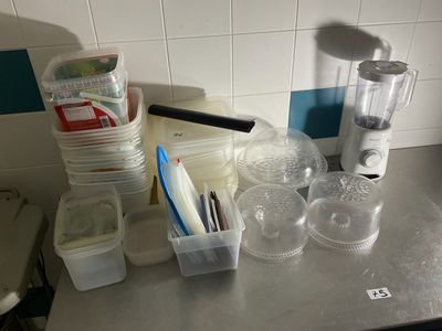 a counter top with a blender, cups, and other items on it