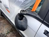 the side view mirror of a car is covered with a plastic sheet