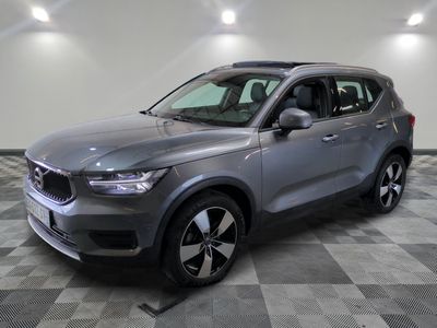 a grey volvo suv parked in a large room with a checkered floor