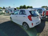 a small white car that is parked in a parking lot
