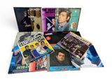 Divers albums vinyles et CD sont empilés les uns sur les autres