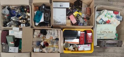 boxes filled with assorted items sitting on top of a wooden floor