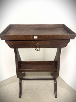 a small wooden table with a drawer on top of it