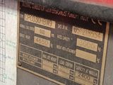 a sign on the side of a red bus
