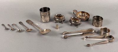 a lot of silver spoons and other silverware on a table