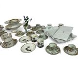 many different types of dishes and cups on the table