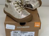 pair of baby shoes in a box on a white surface