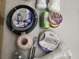 a box of yarn, a spool, scissors, and other items on a table