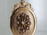 an image of a gold locke with a flower design on it