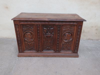 an old wooden chest sitting on top of a cement floor