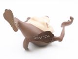 a chocolate dog that is laying down on the ground
