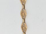 bracelet plaqué or jaune, orné d'un motif en spirale sur le côté