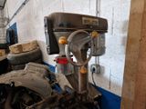 an image of a machine in a garage with a pile of tires