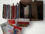 a box full of books on a white table