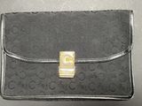 an image of a black purse with a gold buckle on it