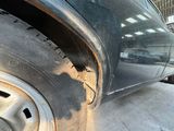 a close up of a tire on a car in a garage