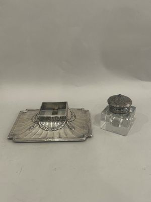 two silver plated candlesticks and a silver plated candle holder