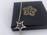 a close up of a black box with a chain and a star on it