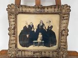 une vieille photo montrant un groupe de personnes assises sur un chevalet en bois