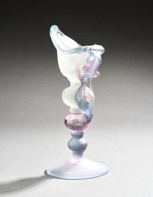 a glass sculpture of a bird on top of a pedestal