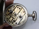 a close up of a person holding a pocket watch