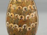 a vase that has a picture of people on it