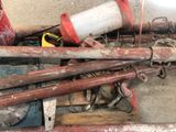 a pile of pipes and other tools on the floor