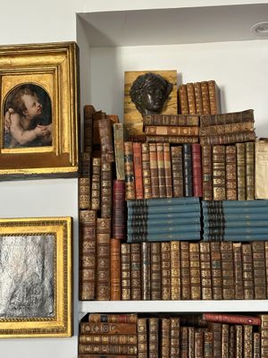 many old books on a shelf in a room