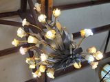 a chandelier made of flowers hanging from the ceiling
