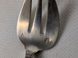 a fork that is sitting on top of a piece of paper