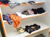 a display of clothes on a shelf in a store
