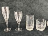a group of wine glasses and a bowl on a table