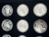 six silver coins are in a black box with a black lid