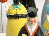 five figurines of people in different colors and sizes