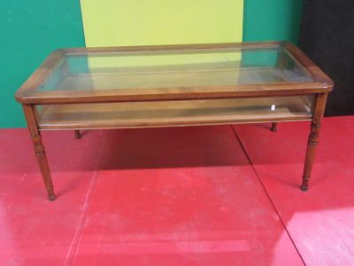 a table with a glass top on a red floor