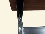 a close up of a metal chair with a wooden seat
