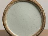 a close up view of a ceramic vase on a table