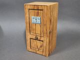 a small wooden box with a clock on top of it