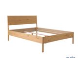 a bed with a wooden headboard and foot board on a white background