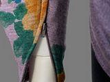 the back of a woman ' s sweater with a zipper on it