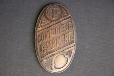 a close up of a metal sign on a table
