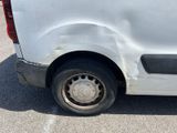 a white van that has a flat tire on the side of it