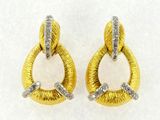 a pair of gold and white earrings with diamonds