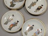 several plates with asian designs on them are sitting on a table