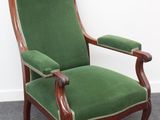 une image représentant une chaise verte posée sur un sol recouvert de moquette