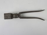 an old pair of tonges sitting on top of a white surface