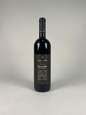 a bottle of red wine sitting on top of a white table